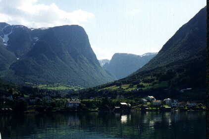 A town along water's edge in fjord country.