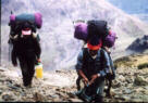 Porters carrying heavy loads.