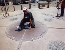 Adam astride Four Corners